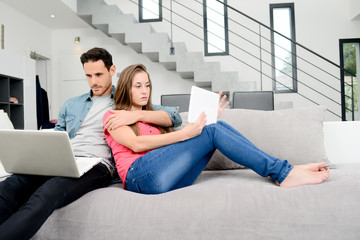 happy young couple relaxed on sofa in a beautiful modern design home