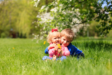 happy kids play with spring flowers 