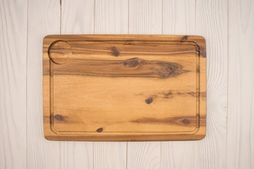 Empty cutting board on planks food background concept