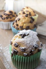 Falling sweet sugar on chocolate muffins