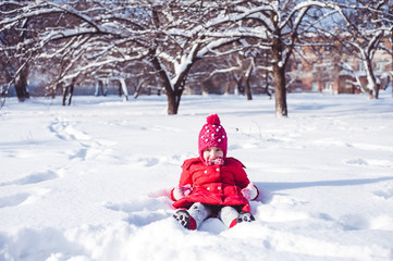 Fototapeta na wymiar Girl lying in the snow