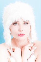 Skin care concept with feminine woman face wearing fur hat