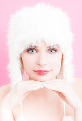 Young woman with perfect makeup wearing a fur hat