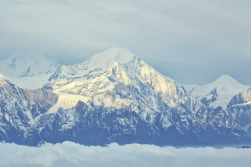 Fototapeta na wymiar beautiful rolling clouds and frozen mountain summits landscape