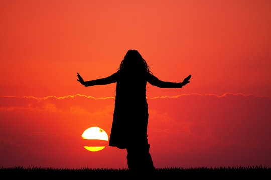 Indian woman dancing at sunset