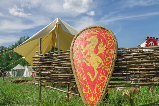 Red knigh'ts shield with family coat of arms on grass