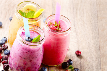 Assorted fruit shakes on white table