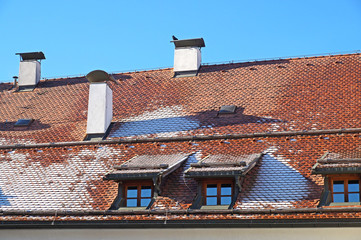 The ice on the roof of the brick house