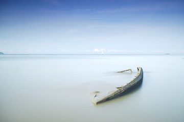 An old fisherman wrecked boat abandoned stand on beach.