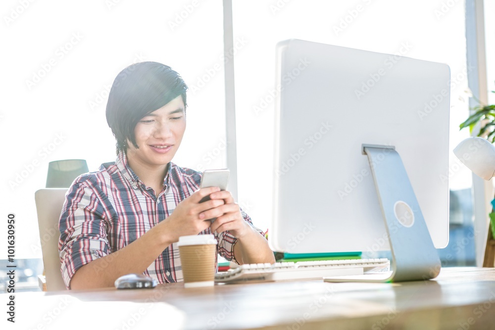 Poster smiling hipster businessman using smartphone
