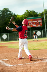 Young little league boy swings bat © tammykayphoto