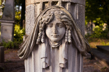 Fototapeta na wymiar Old statue on grave in the Lychakiv cemetery of Lviv, Ukraine
