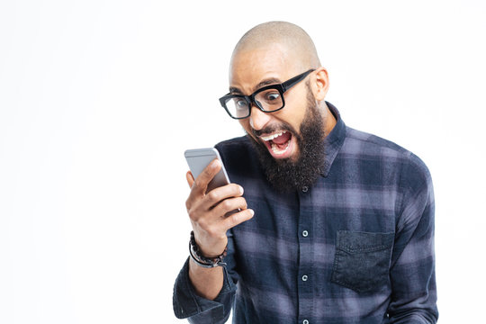 Shocked African American Man Using Mobile Phone And Shouting