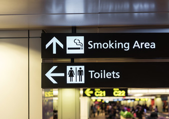Toilets icon. Public restroom signs l and smoking area. Interior of airport terminal.
