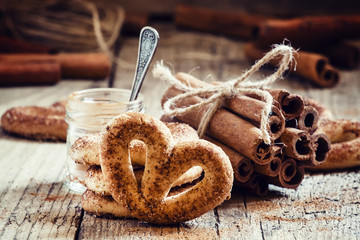 Pretzels with ground cinnamon, cinnamon sticks, brown cane sugar