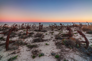 Portuguese beach Tavira, cemetery anchors. Sunset.