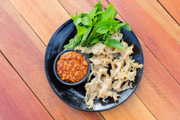 boiled jellyfish with peanut dipping sauce on the black plate