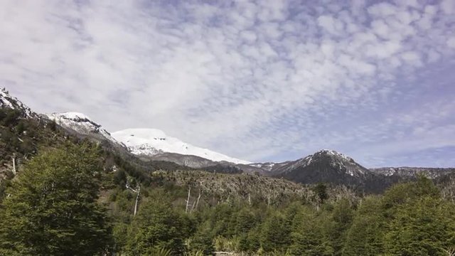 4K time lapse of fast-moving clouds above a snow-capped volcano in Patagonia
