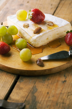 Cheese with strawberries and honey
