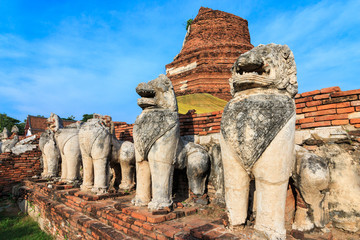 Fototapeta premium Antique Stupa surrounded by Lion statue cambodia style in Thammikarat Temple in Ayutthaya, Thailand