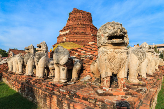 Antique Stupa surrounded by Lion statue cambodia style in Thammikarat Temple in Ayutthaya, Thailand