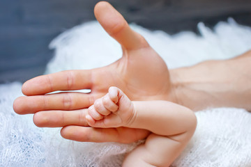 Newborn children's hand in mother hand. Mom and her Child. Happy