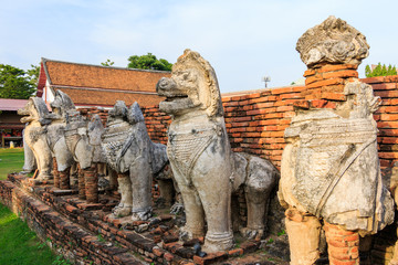 Fototapeta premium Antique Stupa surrounded by Lion statue cambodia style in Thammikarat Temple in Ayutthaya, Thailand
