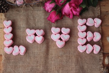 Roses with heart and pink marshmallow for valentine's day.