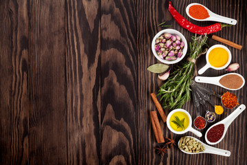 Obraz na płótnie Canvas Herbs and spices over wood background