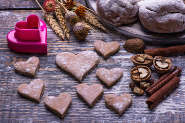 Baking ingredients for making biscuits, cookies in the shape of heart on wooden board. St.Valentines Day.