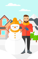 Man posing near snowman.