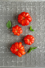 red tomatoes on gray background