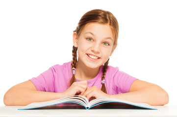One smiling schoolgirl with her textbook