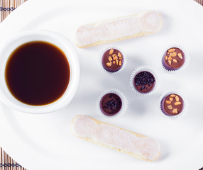 morning coffee chocolate sweets and savoyardi cookies on a white plate