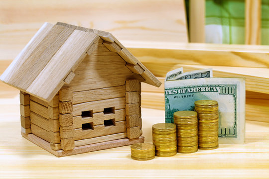 Wooden house block with coins. (finance, property and house loan
