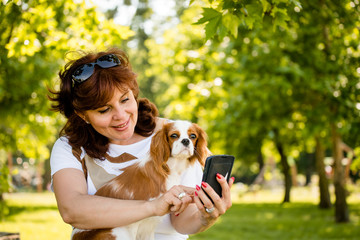 Woman, dog and mobile phone