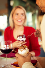 Lovely couple sharing mixed ice cream and enjoying their precious moments. Shallow depth of field, selective focus at ice cream cup.