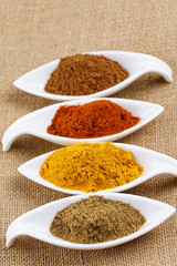 Cinnamon sticks with cinnamon powder on wooden background, Selective focus