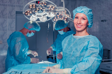 Team surgeon at work in operating room. breast augmentation.