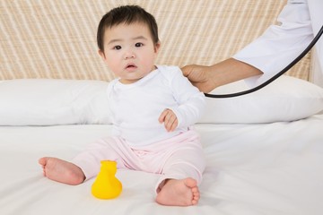 Fototapeta premium Cute baby on bed
