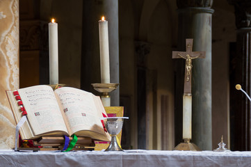 Altar with chalice and Missal during a traditional old latin rite - obrazy, fototapety, plakaty