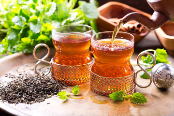 pouring tea into glass
