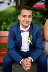Handsome, nice groom on the bench