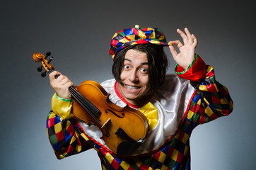 Funny violin clown player in musical concept