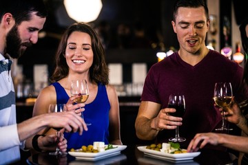 Friends having an aperitif with wine