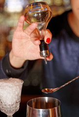 Bartender is adding bitter to shaker