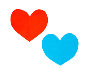Cut red and blue paper hearts together on white background