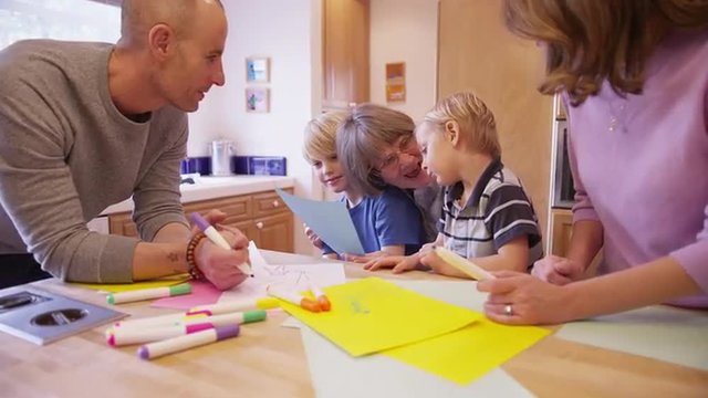 Family visiting grandmother and drawing together