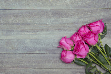 beautiful fresh roses on wooden background