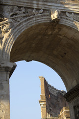 Naklejka premium Roman Colosseum seen through the Arch of Constantine in Rome, Lazio, Italy.